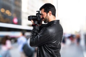 Man with leather jacket photographing